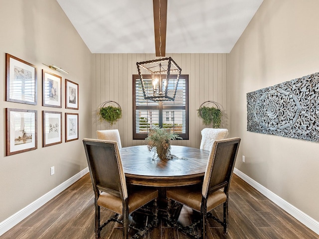 dining room featuring dark wood-type flooring, lofted ceiling with beams, and a notable chandelier