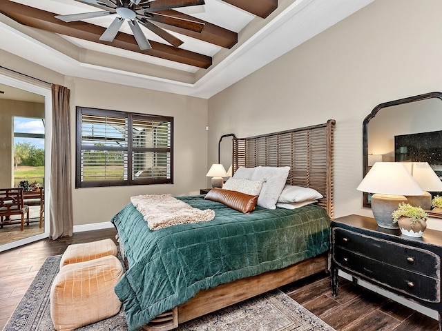 bedroom with access to outside, ceiling fan, dark hardwood / wood-style flooring, and a tray ceiling