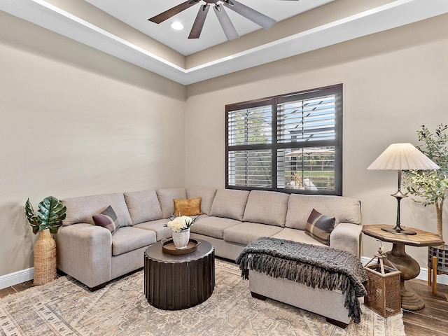 living room with hardwood / wood-style flooring and ceiling fan