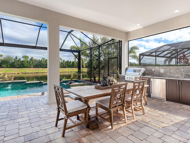 view of patio featuring glass enclosure, exterior kitchen, a grill, a swimming pool with hot tub, and a water view