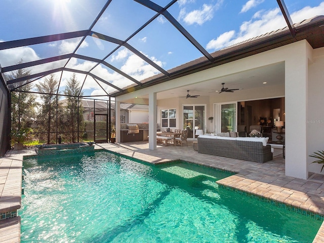 view of swimming pool featuring glass enclosure, exterior kitchen, an outdoor living space, a patio area, and an in ground hot tub