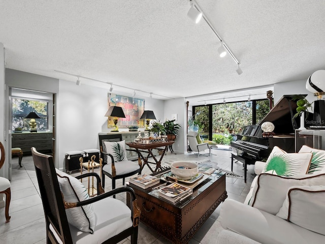 tiled living room featuring a textured ceiling and track lighting