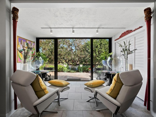 sunroom featuring track lighting