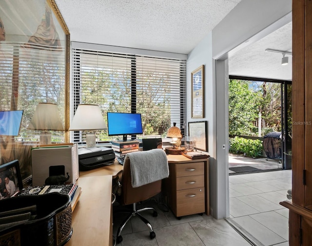 tiled home office with a textured ceiling