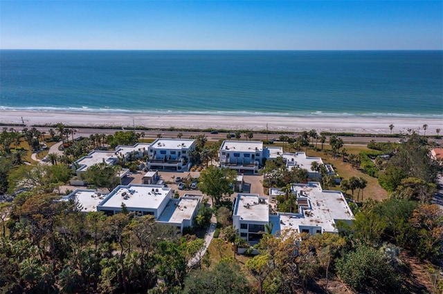 birds eye view of property with a water view and a view of the beach