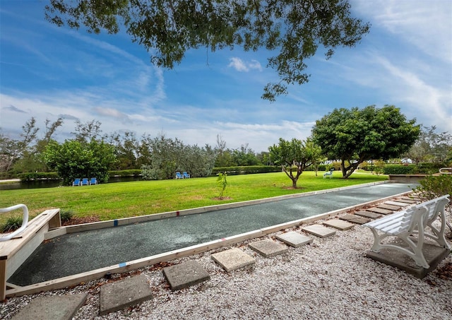 view of home's community featuring a yard and a water view