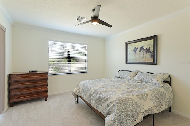 carpeted bedroom featuring ceiling fan and ornamental molding