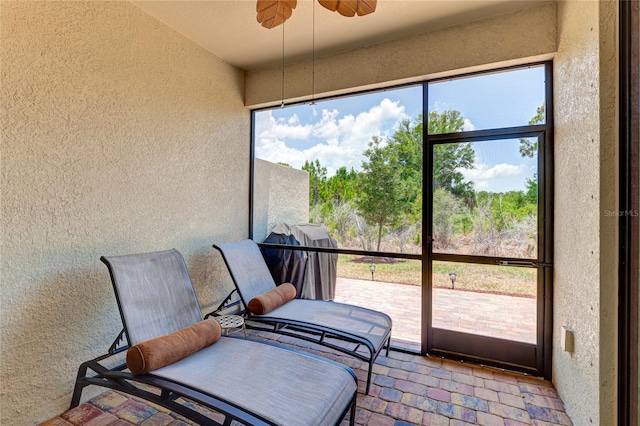 sunroom featuring a hot tub, plenty of natural light, and ceiling fan