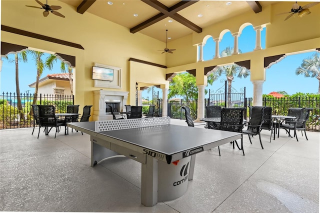 view of patio featuring ceiling fan and a fireplace