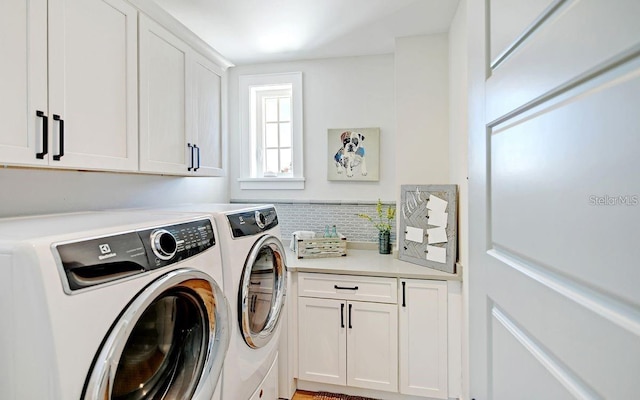 laundry room with cabinets and separate washer and dryer