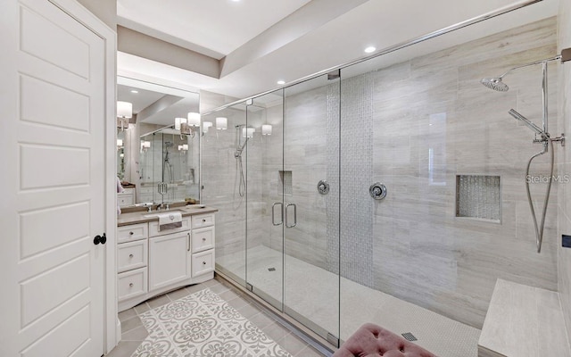 bathroom with tile patterned floors, vanity, and walk in shower