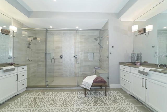 bathroom featuring tile patterned flooring, vanity, and walk in shower