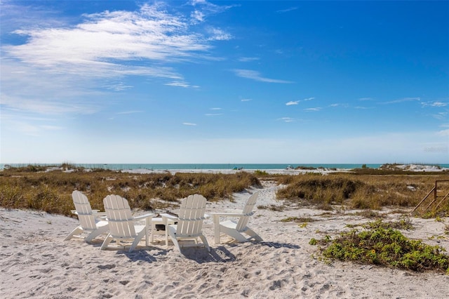 property view of water with a fire pit and a view of the beach