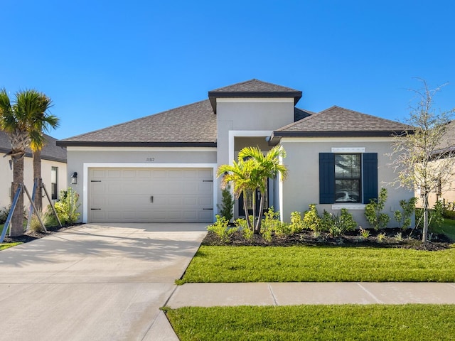 view of front facade featuring a garage and a front lawn