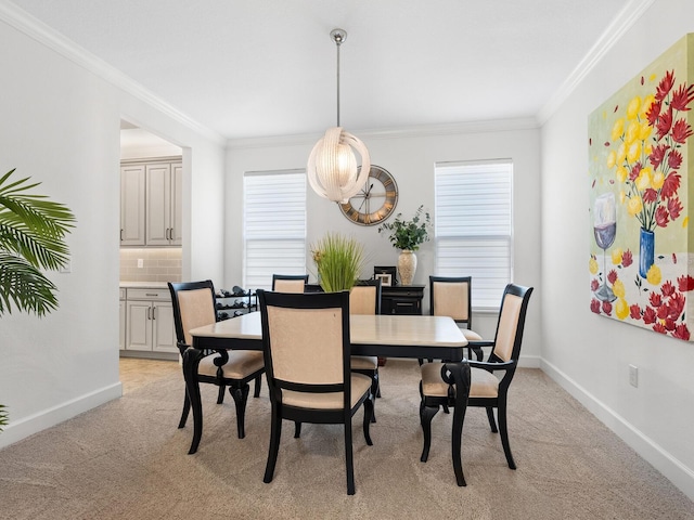 carpeted dining space featuring plenty of natural light and crown molding