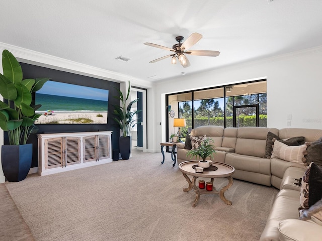 living room featuring ceiling fan, light colored carpet, and ornamental molding