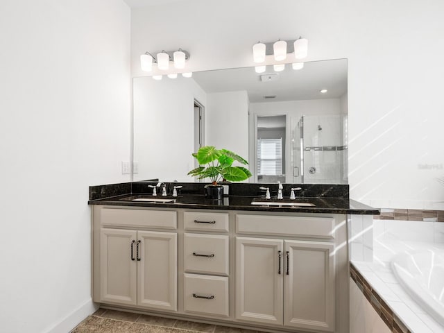 bathroom with vanity, tile patterned flooring, and plus walk in shower