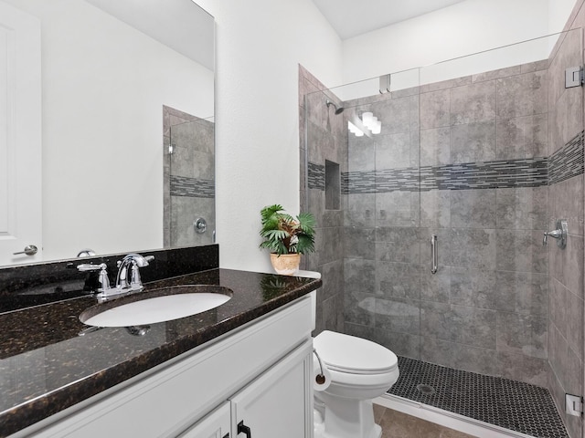 bathroom with vanity, toilet, and an enclosed shower