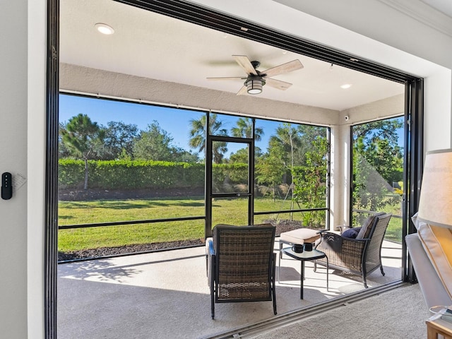 sunroom featuring ceiling fan and a healthy amount of sunlight