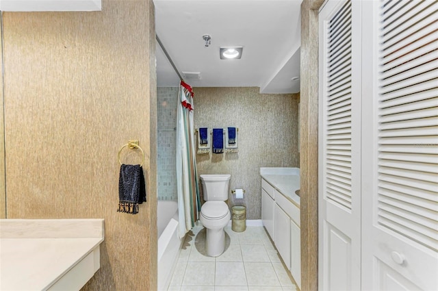 full bathroom featuring tile patterned flooring, vanity, shower / tub combo with curtain, and toilet