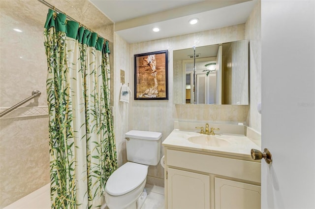 bathroom with tile patterned floors, vanity, toilet, and tile walls