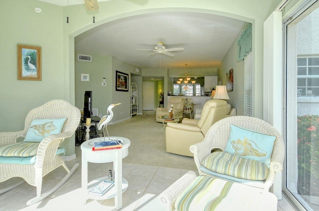 carpeted living room with ceiling fan