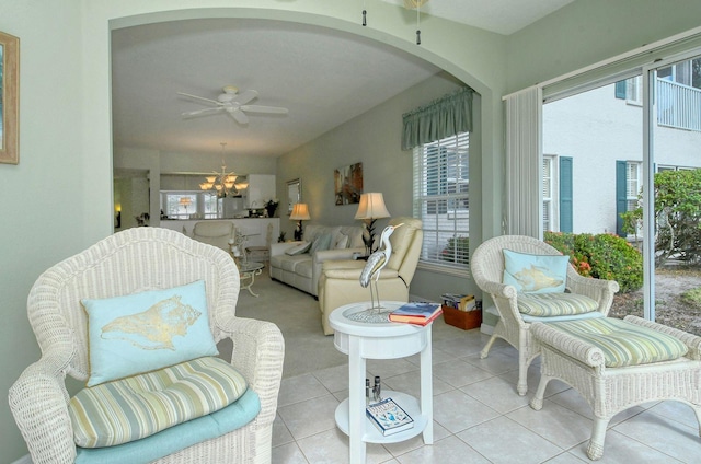 living room with ceiling fan with notable chandelier and light tile patterned flooring