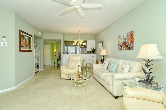 living room with ceiling fan with notable chandelier and light carpet