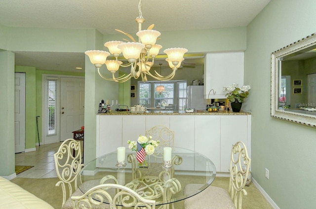 carpeted dining space featuring a textured ceiling and an inviting chandelier