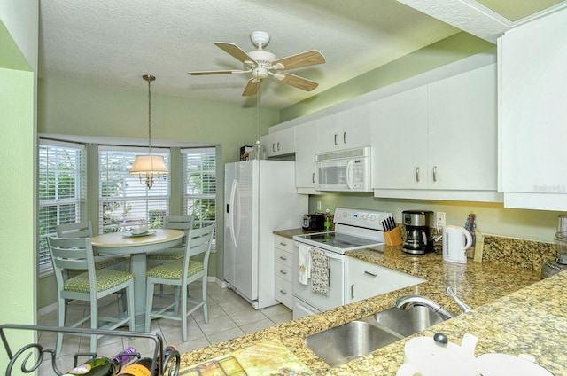 kitchen with a textured ceiling, white appliances, sink, dark stone countertops, and white cabinets