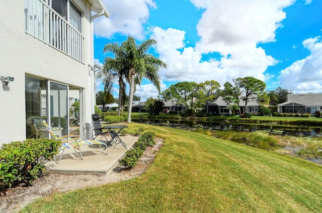 view of yard featuring a patio and a water view