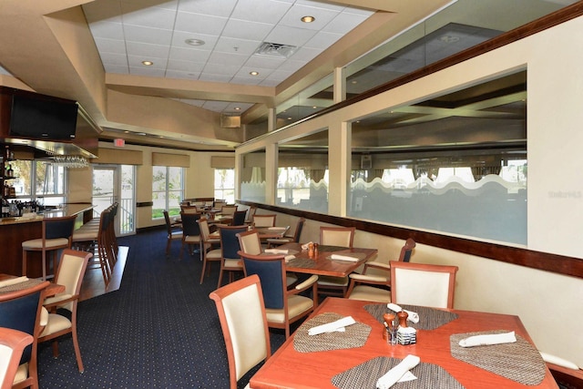 dining area featuring a paneled ceiling