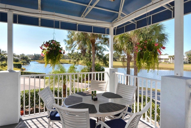 sunroom / solarium with a water view