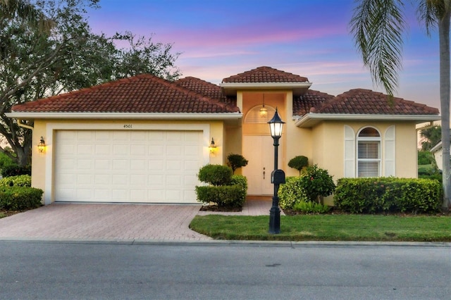 mediterranean / spanish-style home featuring a garage