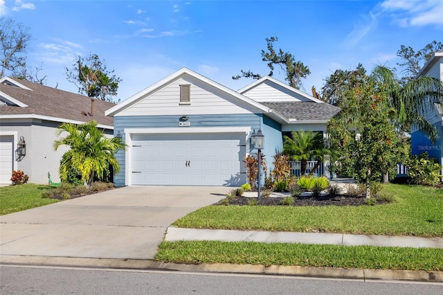 view of front of home with a front lawn and a garage