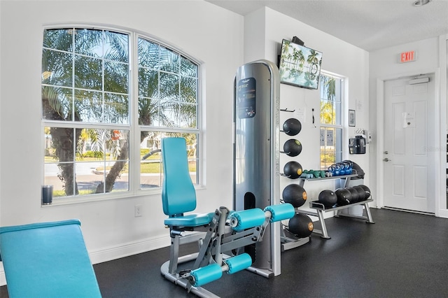 workout room with a textured ceiling and a wealth of natural light