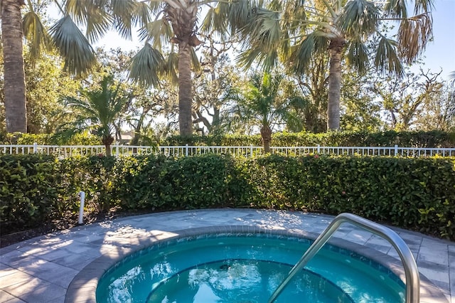 view of pool with an in ground hot tub