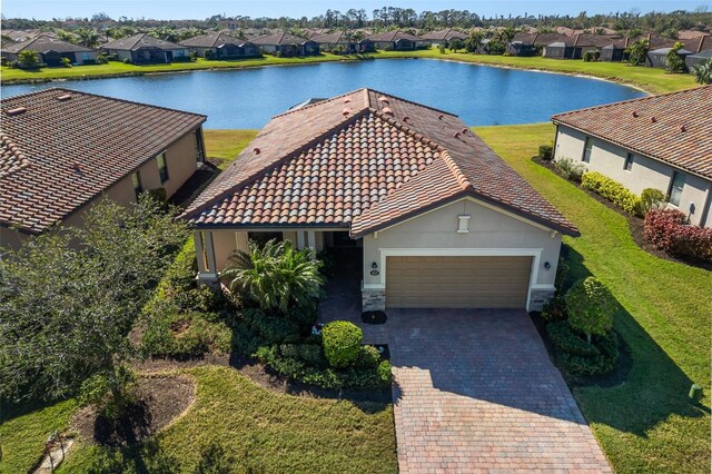 birds eye view of property with a water view