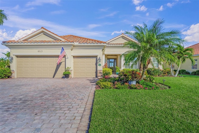 mediterranean / spanish-style house featuring a garage and a front lawn