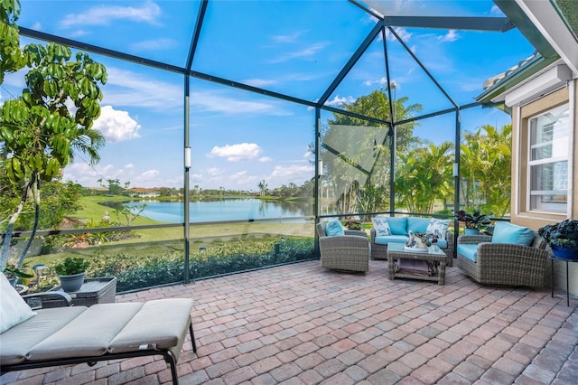 view of patio featuring a lanai, a water view, and an outdoor hangout area