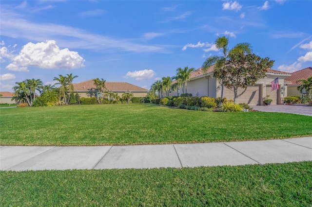 view of front of property featuring a front yard and a garage