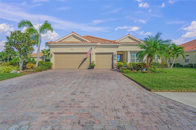 view of front of house with a front yard and a garage