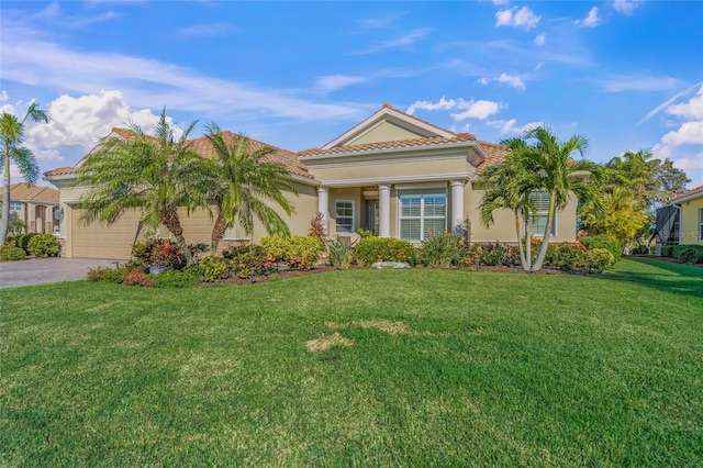 view of front of property featuring a front lawn and a garage