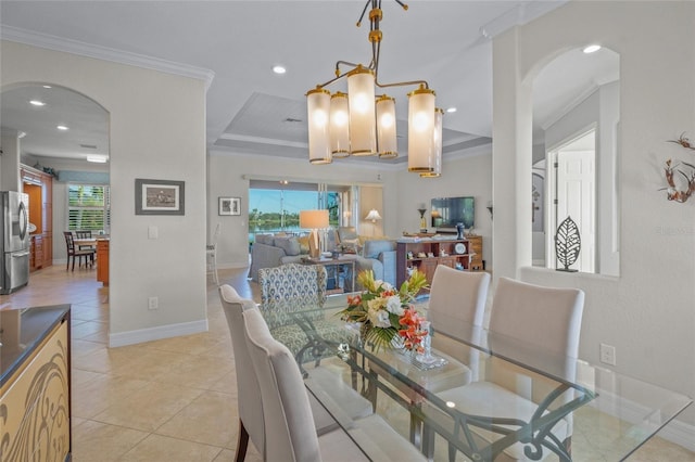 tiled dining space with crown molding and an inviting chandelier