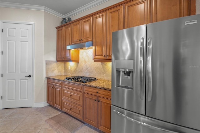 kitchen with light stone countertops, tasteful backsplash, crown molding, light tile patterned flooring, and appliances with stainless steel finishes