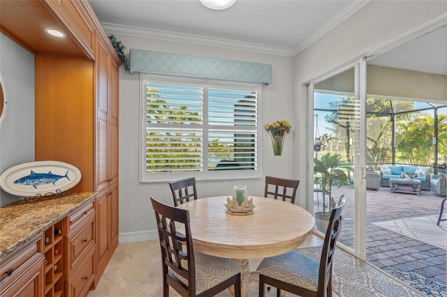 tiled dining area featuring ornamental molding