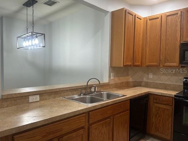 kitchen with black appliances, backsplash, sink, and decorative light fixtures