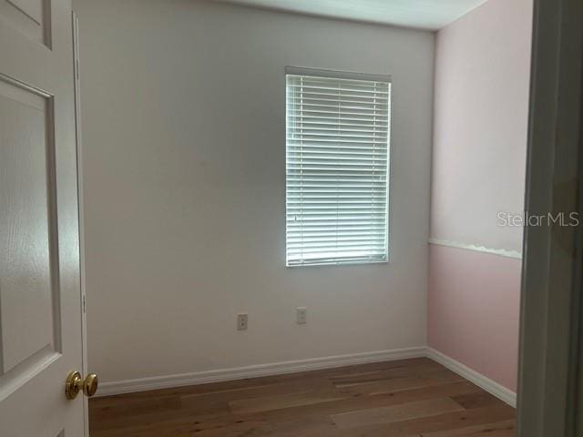 spare room with hardwood / wood-style floors