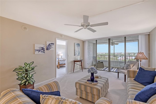 carpeted living room with ceiling fan and floor to ceiling windows