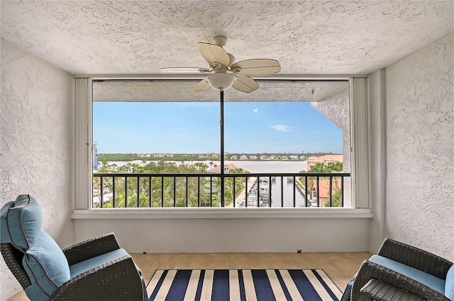 sunroom / solarium featuring ceiling fan